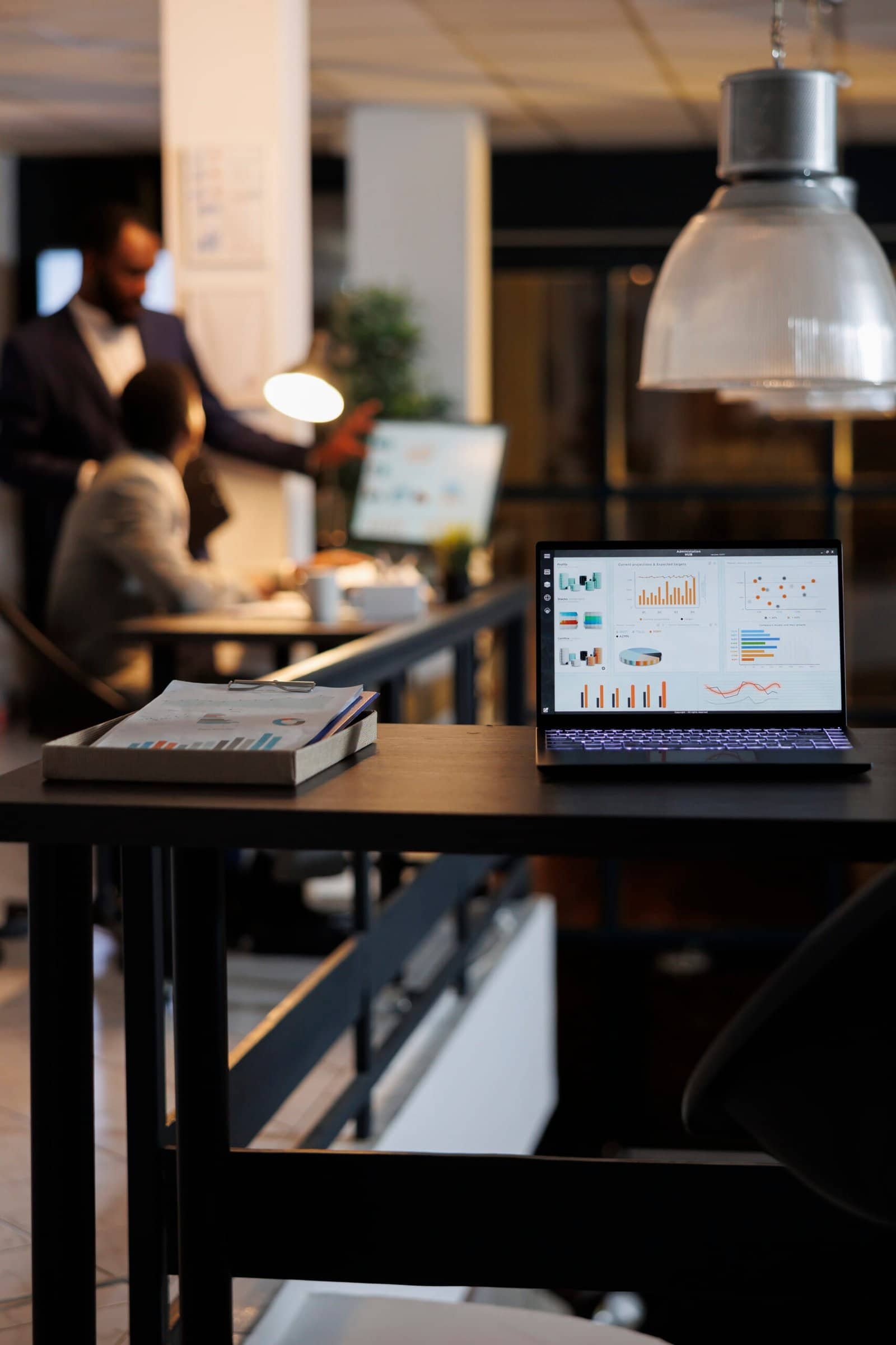 Laptop computer with financial graphs on screen